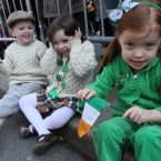 Jack O'Rourke, 4, left, and his twin sister Claire O'Rourke share a laugh as Mia Hayes, 4, right, holds an Irish flag as they watch the St. Patrick's Day Parade make it's way up New York's Fifth Avenue. 

(AP Photo/Tina Fineberg)