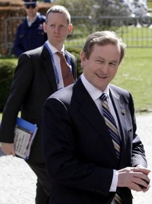 Enda Kenny arrives for a meeting of the European People's Party on the sidelines of an EU summit in Brussels, Thursday, March 24, 2011.