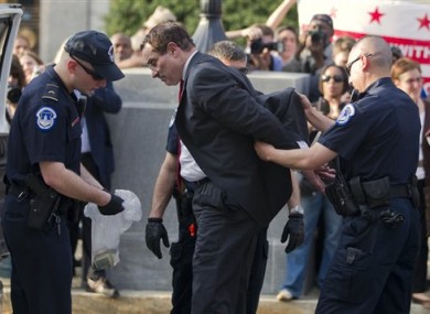 Mayor Vincent Gray is searched by Capitol Hill police after being arrested on Monday, April 11, 2011.