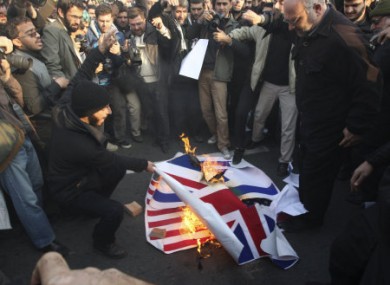 Iranian protesters burning foreign flags outside the British embassy in Tehran yesterday.