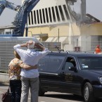 Mr Borghi, who lost his son in the building, embraces his wife in front of the destroyed BBG industrial mouldings in Mirandola, northern Italy, today. A magnitude 5.8 earthquake struck northern Italy, killing at least 10 people as factories, warehouses and a church collapsed in the same region still struggling to recover from another deadly tremor nine days ago. (AP Photo/Luca Bruno)