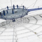 Members of the public are guided along 'Up At the O2' a new visitor attraction which allows visitors to walk across the O2 arena via a suspended fabric walkway 52 meters above ground level to a observation platform offering a 360 degree view of the capital, O2 Arena, London. Thursday, June 21, 2012. (AP Photo/Jonathan Short)