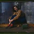 Original caption: A noontime rest for a full-fledged assembly worker at the Long Beach, Calif., plant of Douglas Aircraft Company. Nacelle parts for a heavy bomber form the background.
