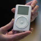 What a game-changer! Introduced in 2001, it allowed people to carry around practically their whole music collection.
This is the original caption from 23 October 2001: Apple's new digital music player, iPod, is displayed after its introduction by Apple Computer Inc. chief executive officer Steve Jobs during a news conference in Cupertino. Macintosh owners can download 1,000 CD-quality songs onto the iPod's five gigabyte hard drive in less than 10 minutes. The MP3 player works only on Macintoshes running Apple's proprietary operating systems and iTunes 2, the company's latest music software. (AP Photo/Julie Jacobson)
