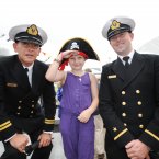 Lt Smith (left) and Ens Carroll with Demi Mooney, 10, from Dublin. (Sasko Lazarov/Photocall Ireland)
