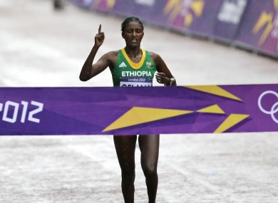 Ethiopia's Tiki Gelana crosses the line to win the gold in the women's marathon at the 2012 Summer Olympics.