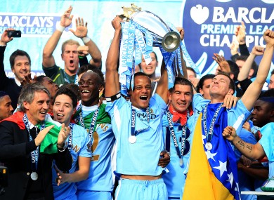 Manchester City captain Vincent Kompany lifts the Premier League trophy.