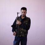 Also 22, Ahmed Al-Saleh is a former policeman. He says he intends to go back to his normal life in the police force if the regime falls. (AP Photo/Muhammed Muheisen)