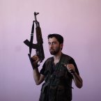 Wisam Al-Saleh is just 21 and is one of thousands of young men to give up their time in school and university to join the fight against the regime. (AP Photo/Muhammed Muheisen)