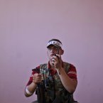 A former construction worker, Mustafa Abu Shaheen, 19, poses for a picture after returning from fighting against Syrian army forces in Aleppo. (AP Photo/Muhammed Muheisen)