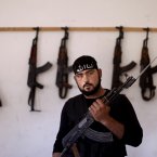 Twenty-four-year-old Mohammed Yaseen was also a construction worker in his previous life. Now, he is getting used to guns, tanks and warfare. (AP Photo/Muhammed Muheisen)