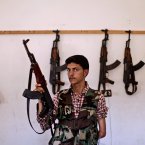 He was still in school when the uprising began but now 20-year-old Ali Alnajjr fights against the president of his country. (AP Photo/Muhammed Muheisen)