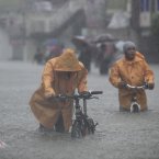 Two men push their bikes along a flooded area in Rizal, east of Manila, Philippines.
(AP Photo/John Javellana)