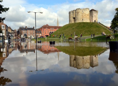 Cliffords Tower, one of York's famous ancient attractions is reflected in floodwater which this morning filled surrounding City Centre roads.
