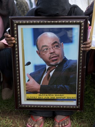 A woman reacts against a portrait of late Prime Minister Meles Zenawi. Three days of commemorative ceremonies are being held in the country to remember the late Prime Minister.