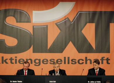 Erich Sixt, center, CEO of the German car rental company Sixt AG waits for the start of the annual shareholders meeting in Munich