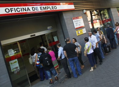 People queue outside an unemployment office in Madrid, Spain.