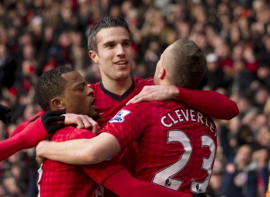 Van Persie is hugged by his team-mates after scoring.