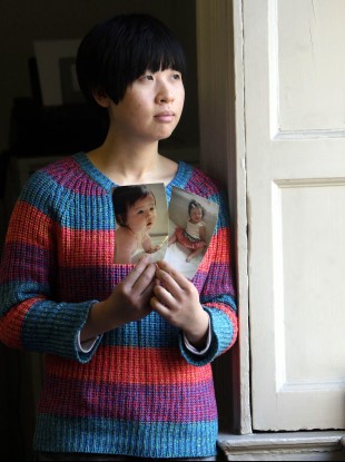 Meijiao Yu holds a picture of her daughter Jiayi.