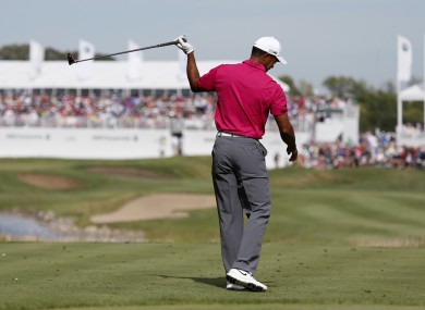 Tiger Woods reacts to a wayaward approach shot during his round of 66.