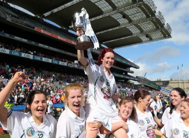 Kildare captain Clodagh Flanagan is carried by her teammates as she holds up the cup.