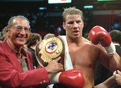 Newly-crowned WBO heavyweight champion Tommy Morrison receives his championship belt after defeating George Foreman.