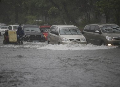 Vehicles cross a flooded street in Manila, Philippines.