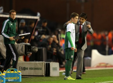 Wales' coach Chris Coleman gives some last minute instruction's to Harry Wilson as he prepares to come on for his debut last night.